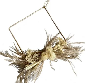 A handcrafted Bleached Golden Dried Wreath, showcasing nature's allure in soothing golden hues.
