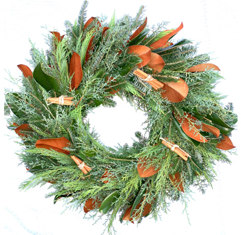 Stocking Stuffer Wreath with cedar, cypress, magnolia leaves, and cinnamon sticks. A fresh, aromatic holiday decoration for indoor or covered outdoor use.