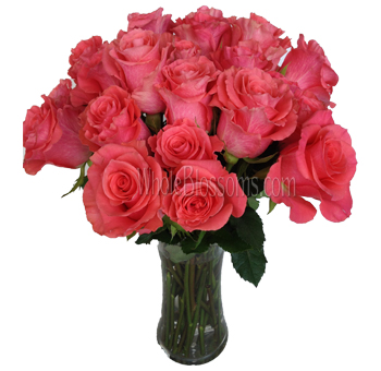 Vase of Amsterdam Coral Roses – vibrant coral blooms arranged in a vase, perfect for weddings and special events, available in bulk from Whole Blossoms.