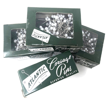 Classic pearl white boutonniere pins, ideal for securing elegant wedding florals, corsages, and formal event arrangements.