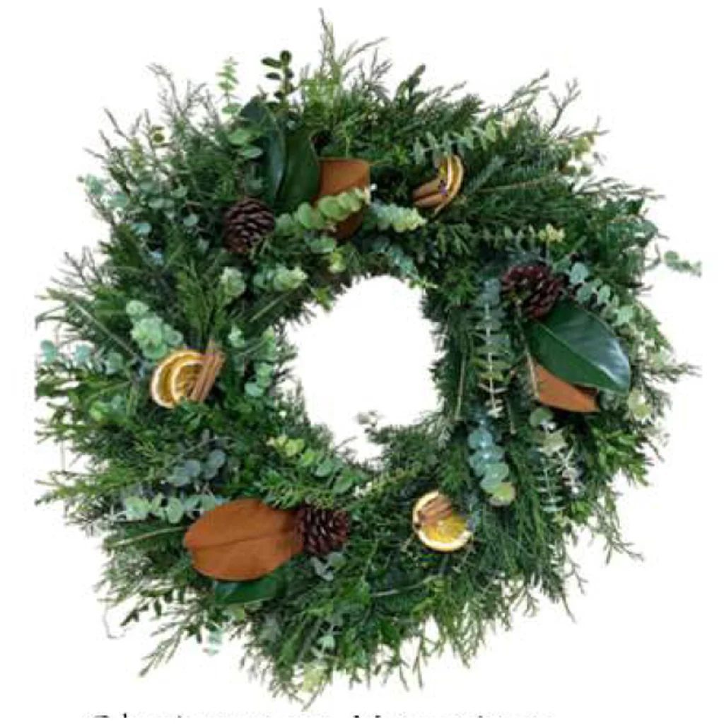 Christmas Morning Wreath with Boxwood, Cedar, Fraser Fir, Magnolia, oranges, cinnamon sticks, and pine cones.