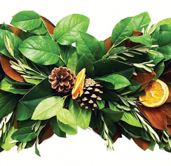Thanksgiving centerpiece with greenery, dried oranges accents.