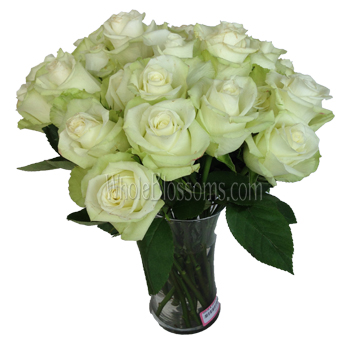 A bouquet of High and Peace Roses in a clear glass vase, showcasing creamy white petals and lush green leaves, perfect for elegant floral displays.