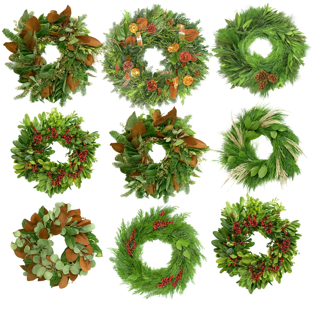 Fresh holiday wreaths made with winter greenery, berries, magnolia, and festive accents on a white background.