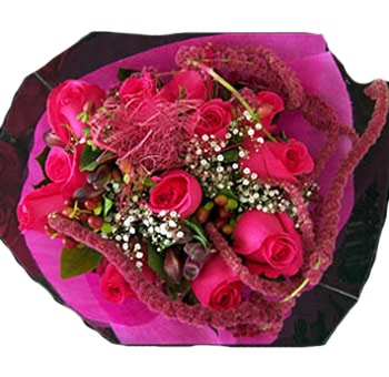 Beautiful Mother's Day centerpiece featuring vibrant pink roses, delicate baby's breath, and textured pink accents, arranged with lush greenery and wrapped in a striking pink and dark decorative cover.