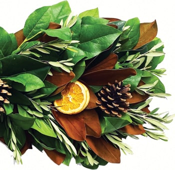 Elegant Thanksgiving foliage featuring lush greenery and dried citrus slices.