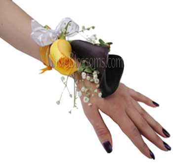 Wedding wrist corsage with yellow rose, black calla lily, and delicate filler flowers for mothers and special event guests.