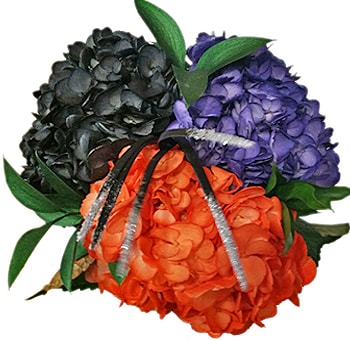 Close-up of preserved Monster Mash hydrangeas in vibrant black, orange, and purple hues, tied with festive pipe cleaners for Halloween-themed design.