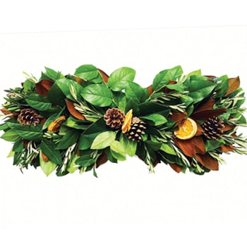 A long, vibrant centerpiece with greenery, dried fruit, and natural seasonal elements.