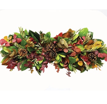Eye-catching table centerpiece combining greenery, dried citrus, and festive textures.