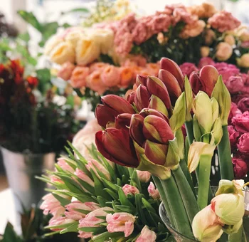 Vibrant bulk fall flowers including tulips, ranunculus, and other fall flowers bursting with rich autumn hues in an elegant display.