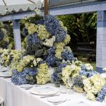 Wedding reception table with blue and green hydrangeas.