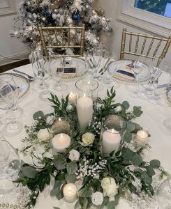 Reception table for white wedding flowers and candles.