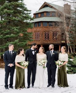 Bridal party having a wedding photo outside in the snow.