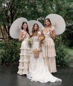 Bridal party with wedding bouquet and Victorian dresses.