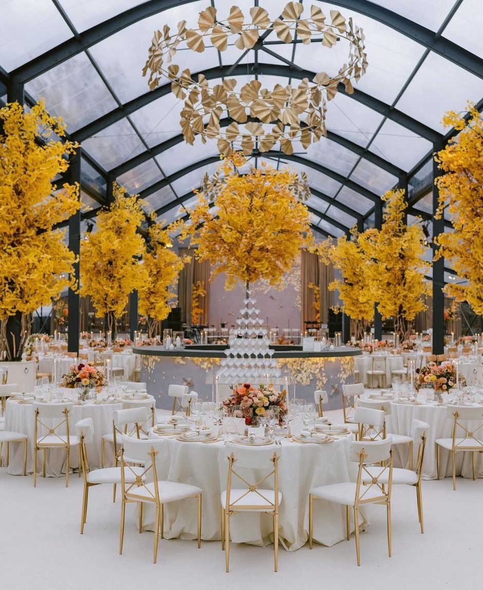 Tablescapes for wedding reception with yellow and peach flowers.