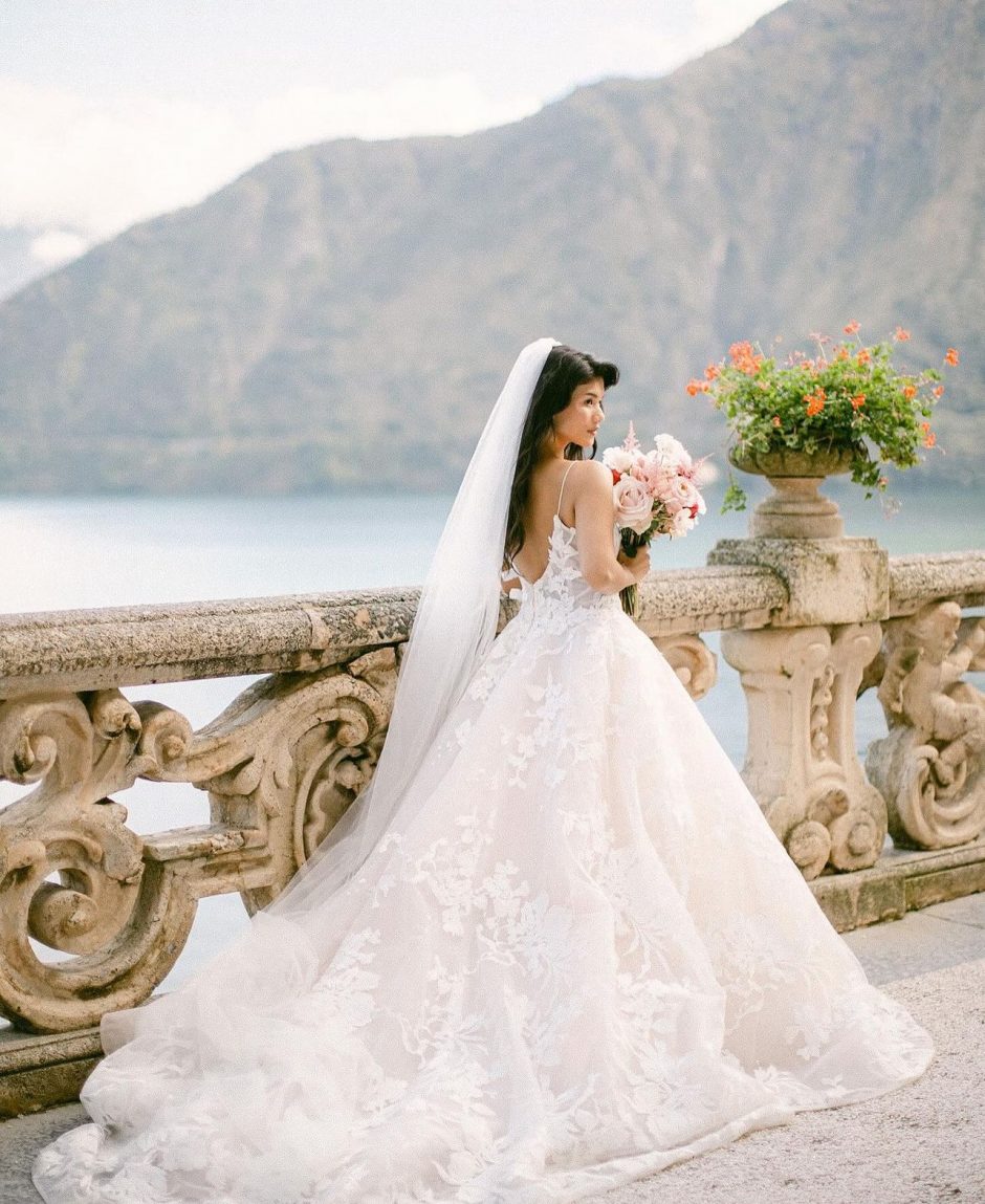 Bride in Italian villa with light pink flowers.