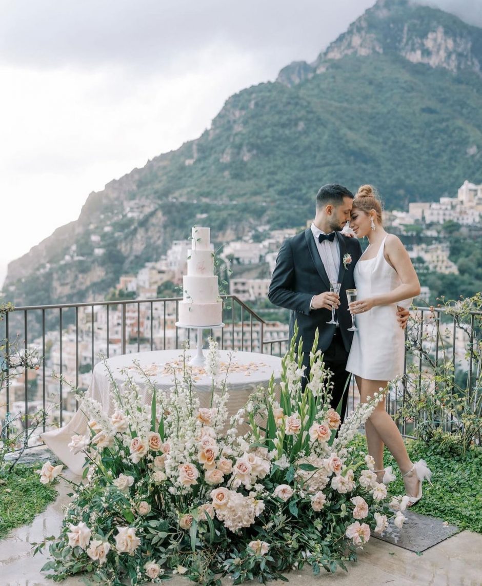 Italian coastal wedding theme with cream flowers.