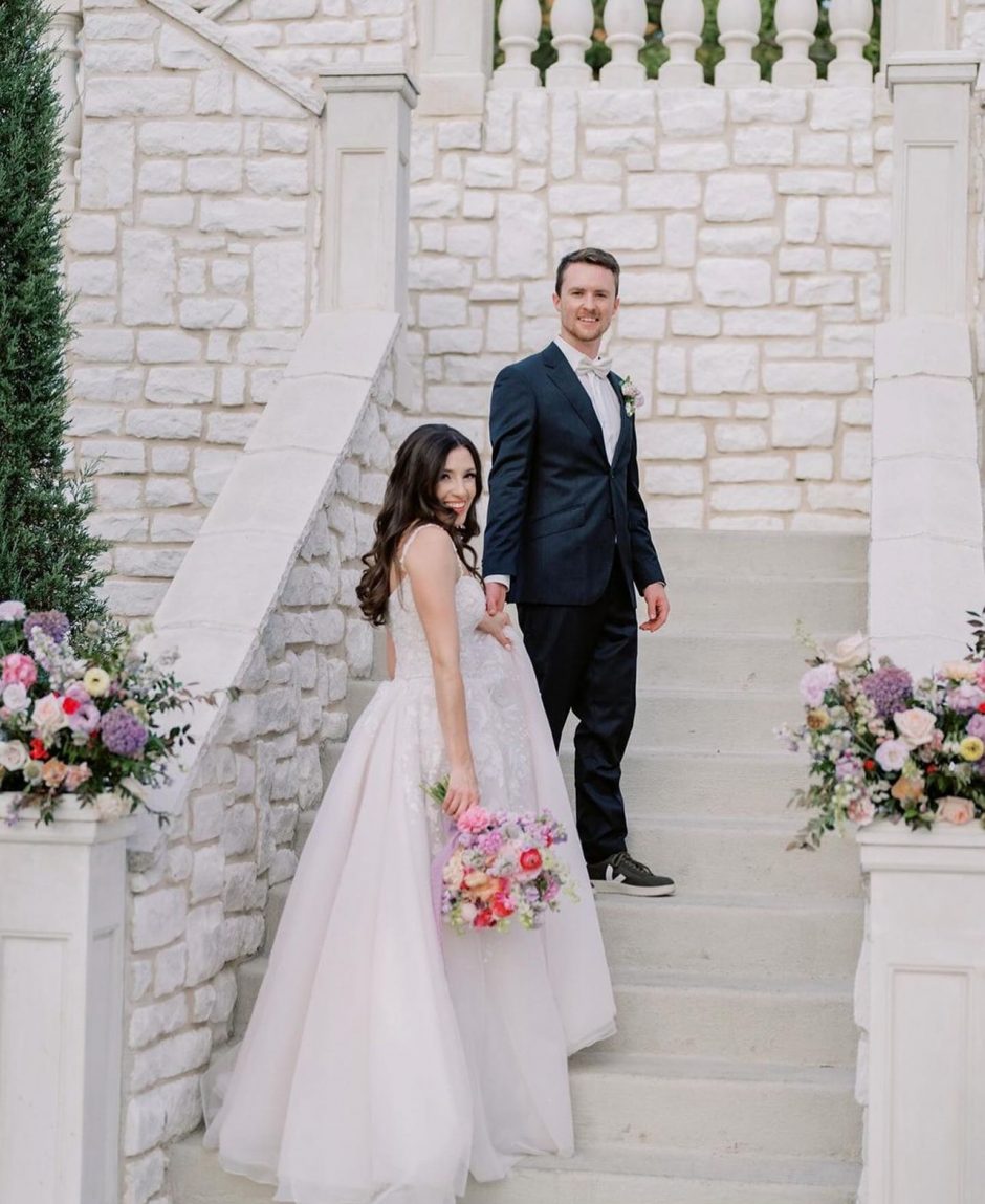 Wedding entrance with pink and purple flowers.