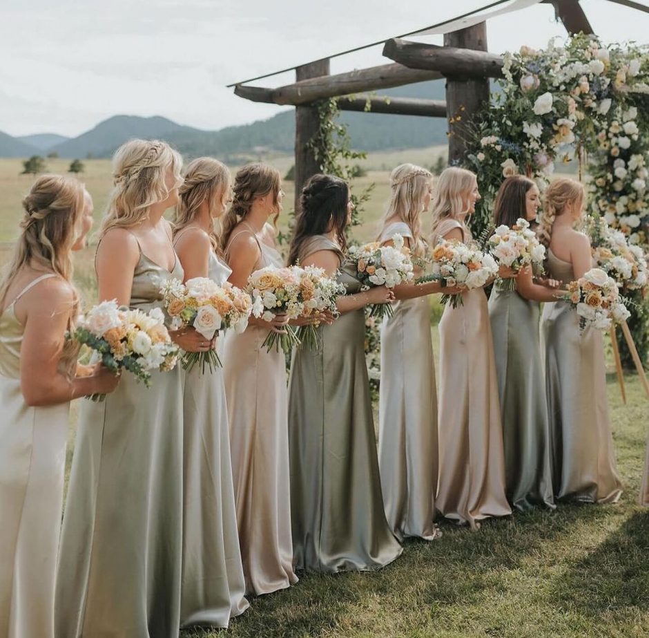 Bridal party with champagne and gold colored florals.