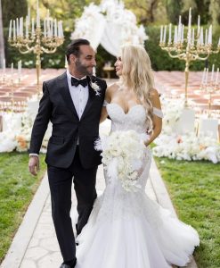 Couple with retro glam 1950's Hollywood wedding theme with flowers.