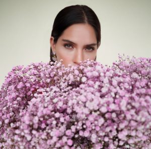 Woman holding bouquet of pink baby's breath.