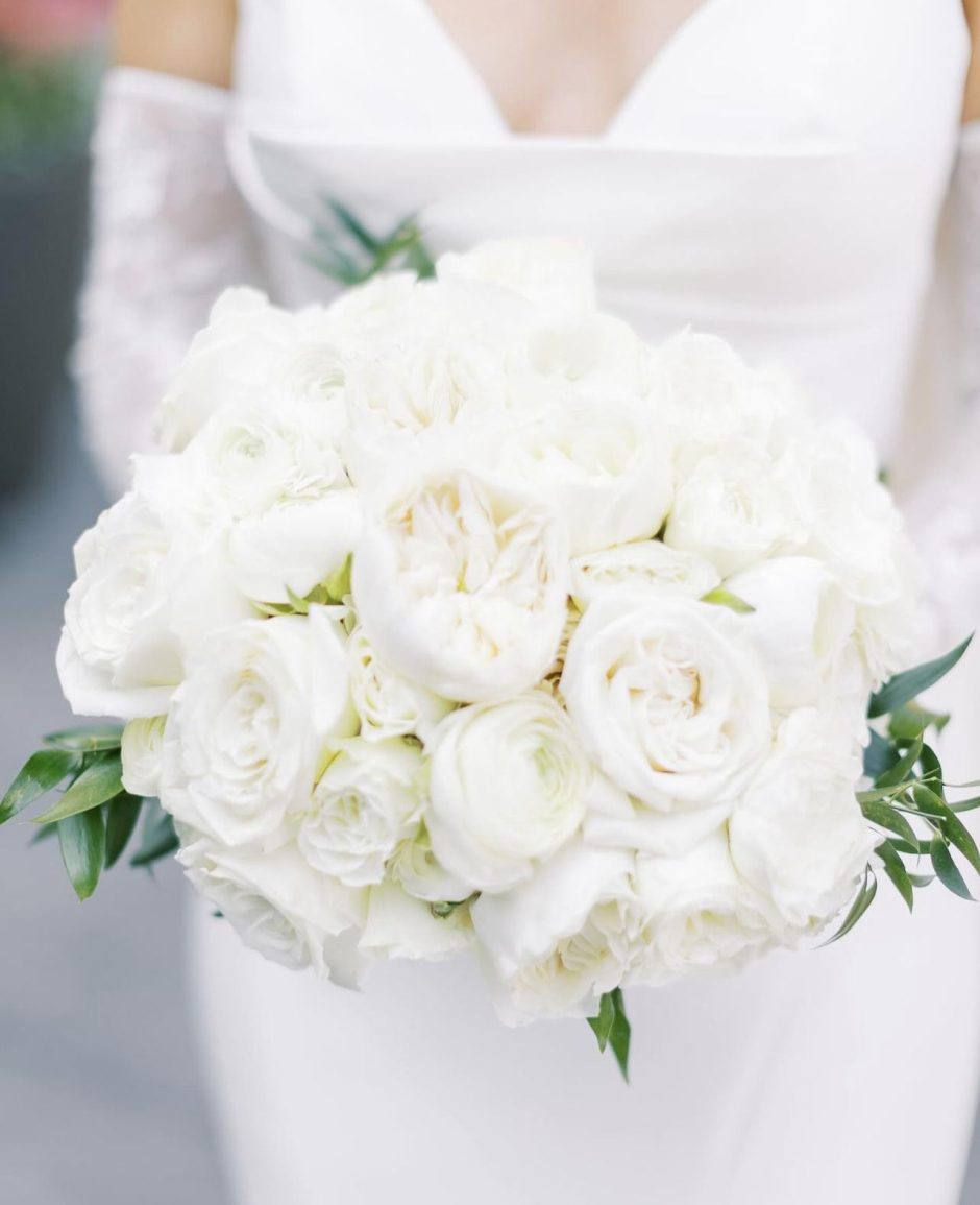 Bride with wedding bouquet with white flowers.