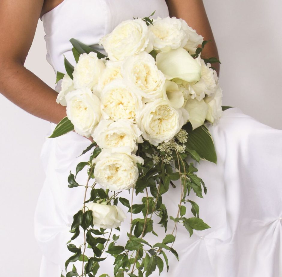 Bride holding Patience Ivory Cream Roses.