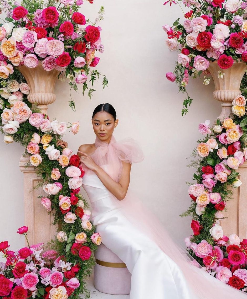 Bride with backdrop of pink garden rose varieties.