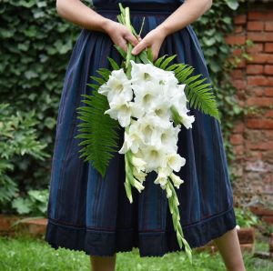 Bride holding bouquet with white gladiolus.