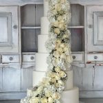 Wedding cake decorated with beautiful fresh cut flowers.